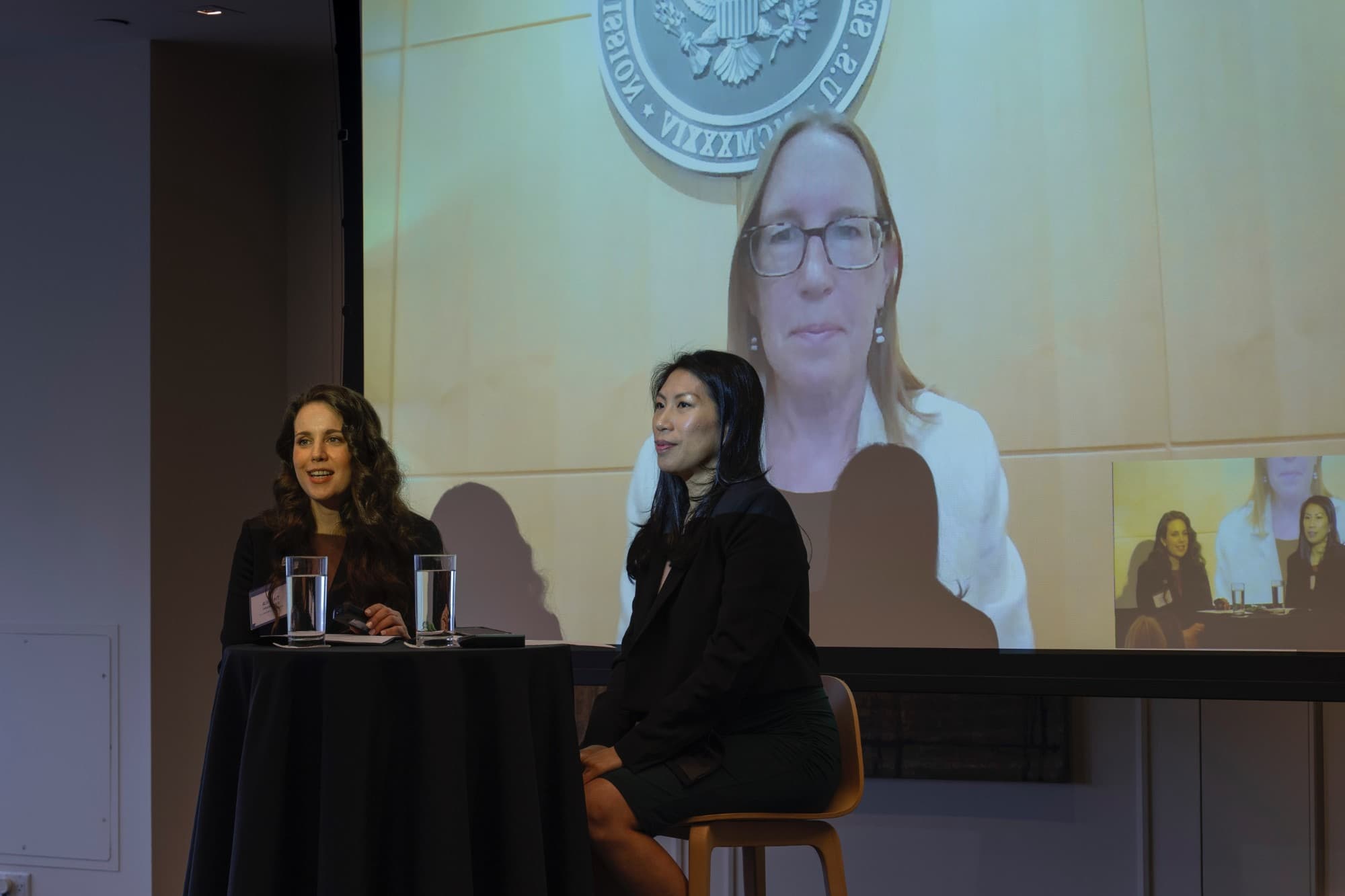 Fireside chat on stage with SEC Commissioner Hester Peirce on screen
